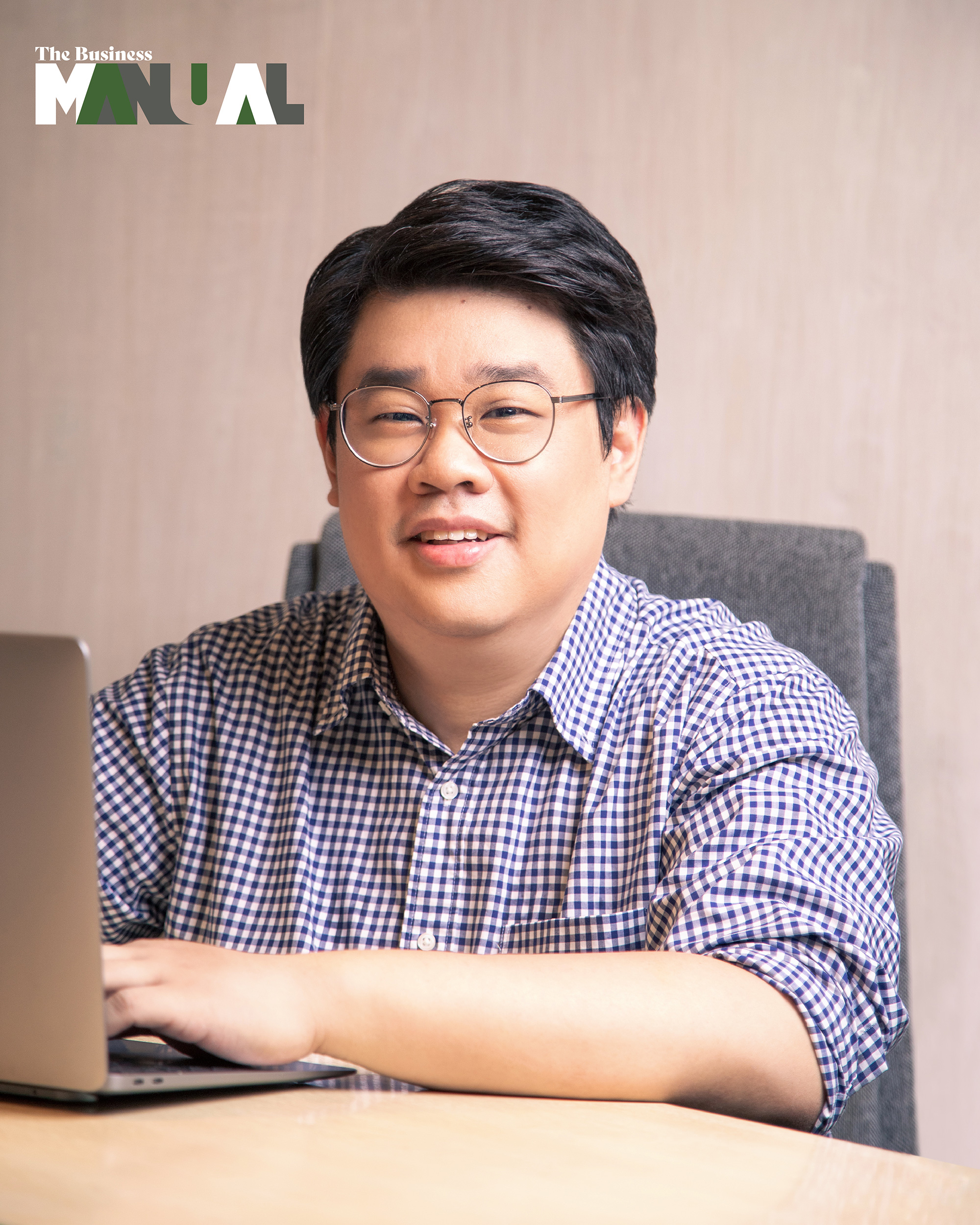 Anton Bautista, Senior Director for Deliveries and Business Development of Grab Philippines, with a laptop
