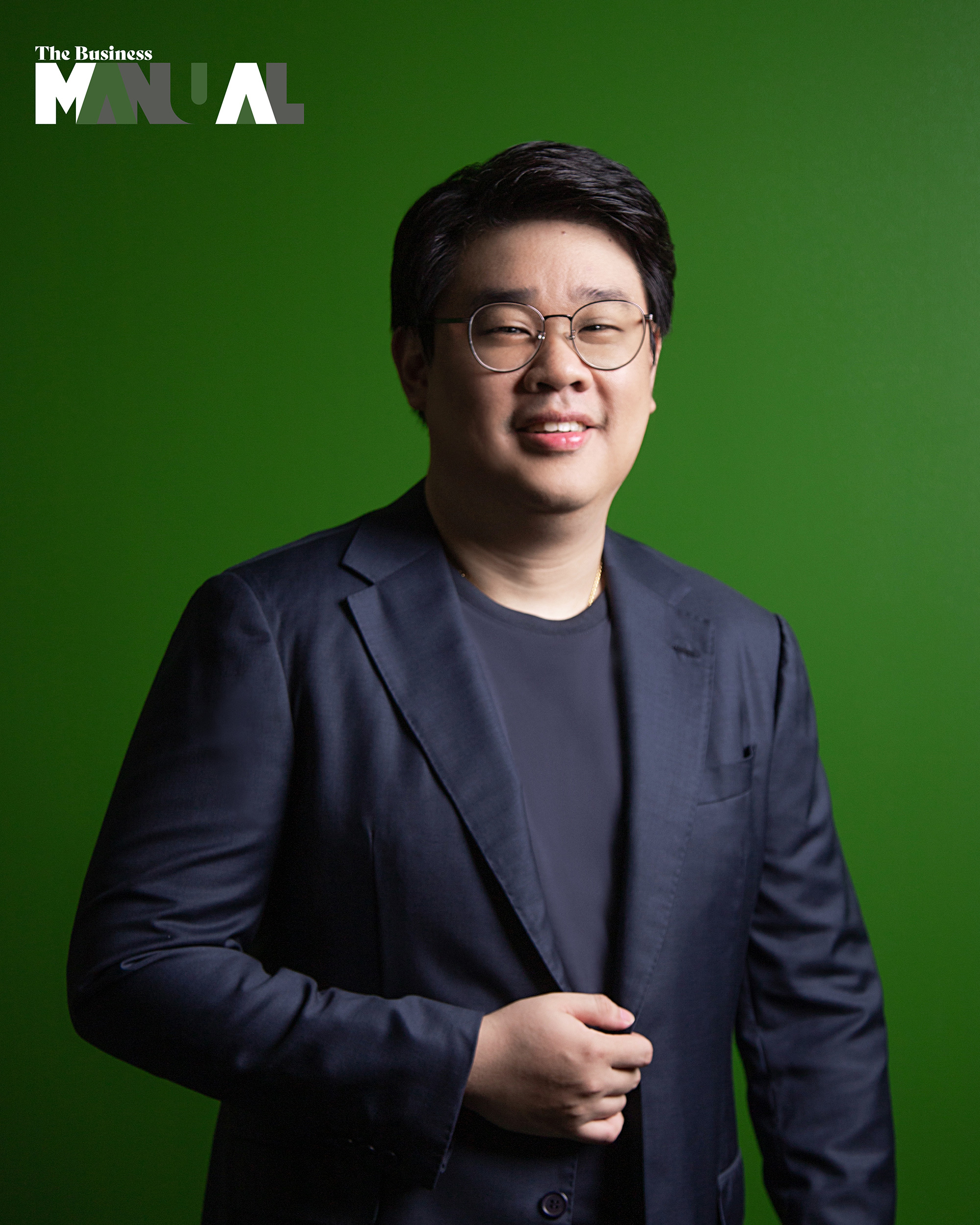 Anton Bautista, Senior Director for Deliveries and Business Development of Grab Philippines in the Grab office, green wall